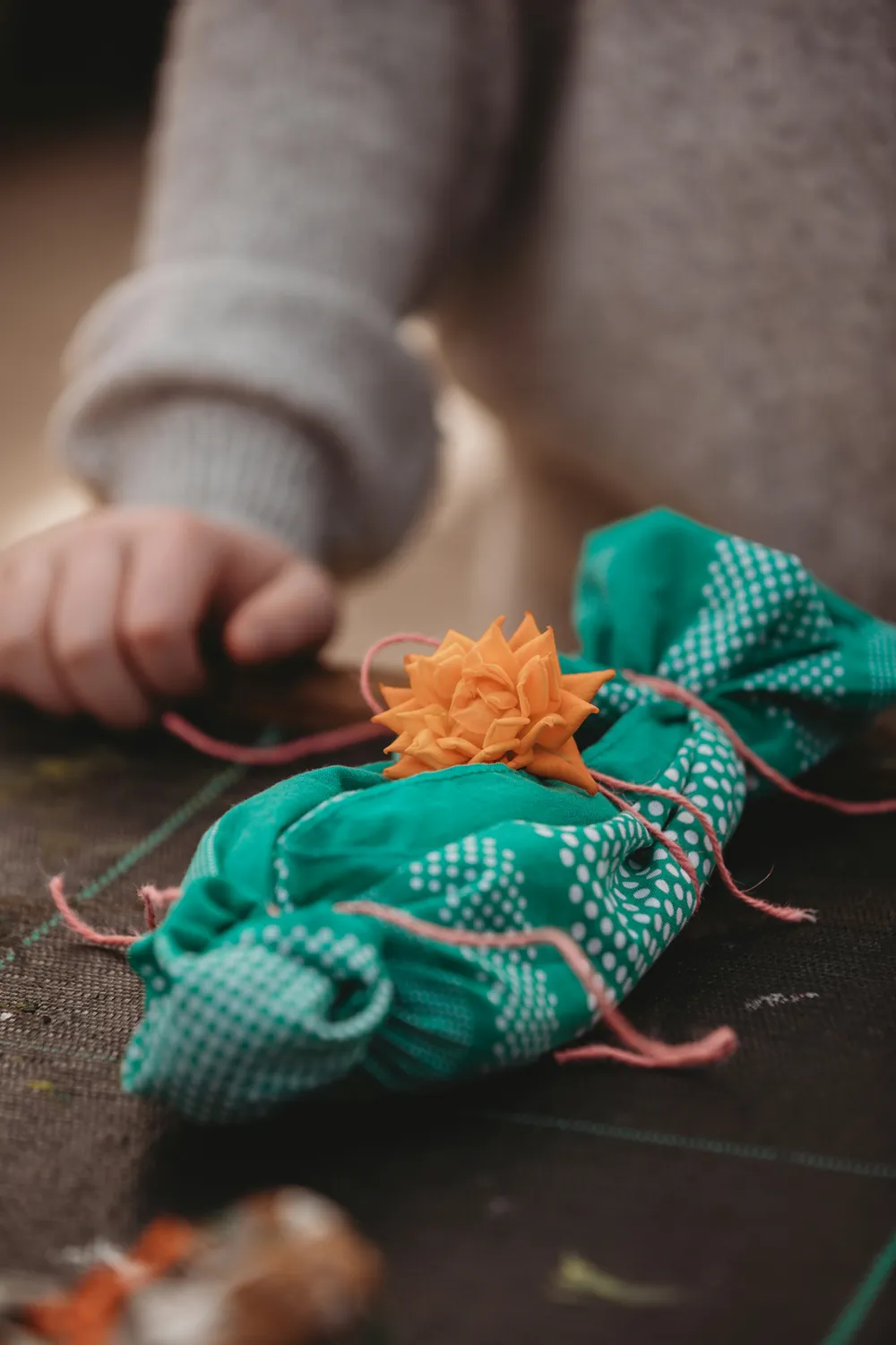 Lifestyle inspiration: hands carefully wrapping a handmade gift
